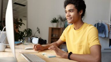 young man at computer desk using eleven labs a.i
