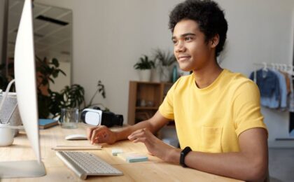 young man at computer desk using eleven labs a.i